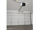 Spacious garage featuring a white paneled door with automated opener at 20941 N Leona Blvd, Maricopa, AZ 85138