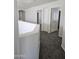 Upstairs hallway with neutral carpet, closets and doorways to bedrooms at 20941 N Leona Blvd, Maricopa, AZ 85138