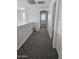 Hallway with carpet, neutral paint, overhead lighting, and an arched doorway at 20941 N Leona Blvd, Maricopa, AZ 85138