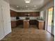 Bright kitchen featuring tile floors, wooden cabinets, and stainless steel appliances at 20941 N Leona Blvd, Maricopa, AZ 85138