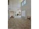 Bright living room with high ceilings, tile flooring, neutral walls, and plenty of natural light at 20941 N Leona Blvd, Maricopa, AZ 85138