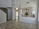 Open concept living space featuring neutral walls, tile floors, a dining area, and staircase at 20941 N Leona Blvd, Maricopa, AZ 85138