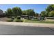 Community park with a covered picnic area, playground, grassy areas, trees, and landscaping at 20941 N Leona Blvd, Maricopa, AZ 85138