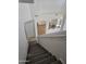 Carpeted staircase leading from the upstairs landing to the lower level living spaces at 20941 N Leona Blvd, Maricopa, AZ 85138