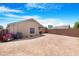 Spacious dirt backyard with privacy fence and covered patio at 22576 N Davis Way, Maricopa, AZ 85138