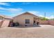 Spacious dirt backyard with privacy fence and covered patio at 22576 N Davis Way, Maricopa, AZ 85138