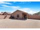Spacious dirt backyard with privacy fence and covered patio at 22576 N Davis Way, Maricopa, AZ 85138