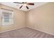 Relaxing bedroom with carpet flooring, neutral colors, and a window at 22576 N Davis Way, Maricopa, AZ 85138