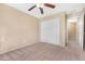 Cozy bedroom showcasing carpet flooring, a ceiling fan, and closet at 22576 N Davis Way, Maricopa, AZ 85138