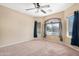 Bedroom featuring carpet floors, a ceiling fan, and sunburst window at 22576 N Davis Way, Maricopa, AZ 85138