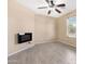 Neutral bedroom includes tile flooring and electric fireplace at 22576 N Davis Way, Maricopa, AZ 85138