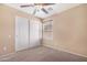 Bedroom featuring carpet floors, a ceiling fan, and a window at 22576 N Davis Way, Maricopa, AZ 85138