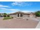 Inviting home boasts a well-manicured lawn, mature plants, and desert landscaping at 22576 N Davis Way, Maricopa, AZ 85138