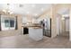 Open kitchen with stainless appliances, an island, and stylish tile flooring for modern living at 22576 N Davis Way, Maricopa, AZ 85138