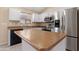 Updated kitchen features stainless appliances, neutral countertops, and a central island at 22576 N Davis Way, Maricopa, AZ 85138