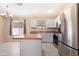 Bright kitchen boasts stainless steel appliances, a functional island, and modern finishes at 22576 N Davis Way, Maricopa, AZ 85138