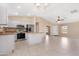 Open-concept kitchen features white cabinets, stainless steel appliances, and island with breakfast bar at 22576 N Davis Way, Maricopa, AZ 85138