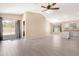 Spacious living room features tile floors, neutral paint, and sliding doors to backyard at 22576 N Davis Way, Maricopa, AZ 85138