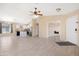Bright living room boasts neutral colors, tiled floors, and an open layout to the kitchen at 22576 N Davis Way, Maricopa, AZ 85138