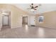 Bright living room with neutral colors and tiled floors offers a welcoming entrance to the home at 22576 N Davis Way, Maricopa, AZ 85138