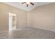 Neutral main bedroom with tiled floors and ensuite bathroom access at 22576 N Davis Way, Maricopa, AZ 85138