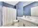 Bathroom features a white vanity and shower with white curtain at 23937 W Hopi St, Buckeye, AZ 85326