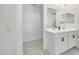 Modern bathroom featuring double sinks, white cabinets, modern hardware and lighting fixtures at 23937 W Hopi St, Buckeye, AZ 85326