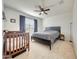 Bedroom features a ceiling fan, neutral carpet, and a window that provides natural light at 23937 W Hopi St, Buckeye, AZ 85326