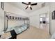 Bedroom with bunk beds features a ceiling fan and natural light at 23937 W Hopi St, Buckeye, AZ 85326