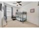 Bedroom with bunk beds features a ceiling fan and natural light at 23937 W Hopi St, Buckeye, AZ 85326