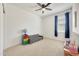Bright bedroom features a ceiling fan and natural light at 23937 W Hopi St, Buckeye, AZ 85326