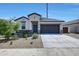 Charming single-story home featuring a well-manicured yard and a two-car garage at 23937 W Hopi St, Buckeye, AZ 85326