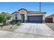 Charming single-story home featuring a well-manicured yard and a two-car garage at 23937 W Hopi St, Buckeye, AZ 85326