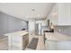Bright kitchen with white cabinets, stainless steel appliances, and a large island at 23937 W Hopi St, Buckeye, AZ 85326