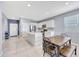 Bright kitchen features white cabinetry, stainless appliances and a large island with a sink and breakfast bar at 23937 W Hopi St, Buckeye, AZ 85326