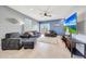 Cozy living room with tile floors, a ceiling fan, and sliding glass doors at 23937 W Hopi St, Buckeye, AZ 85326