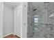 Updated shower featuring a glass enclosure, gray marble-style tiling, and modern fixtures at 2400 E Baseline Ave # 228, Apache Junction, AZ 85119