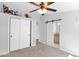 Neutral bedroom featuring plush carpet, closet, and access to a bathroom with a sliding barn door at 2400 E Baseline Ave # 228, Apache Junction, AZ 85119