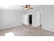 Spacious, light-filled bedroom featuring a ceiling fan, neutral carpet, and walk-in closet at 2400 E Baseline Ave # 228, Apache Junction, AZ 85119