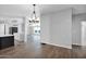 Open-concept dining room with hardwood flooring and views to the kitchen and living room at 2400 E Baseline Ave # 228, Apache Junction, AZ 85119