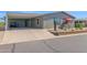 Charming home with covered carport, xeriscaped front yard, and quaint patio seating area at 2400 E Baseline Ave # 228, Apache Junction, AZ 85119