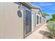 Charming home featuring a modern metal door with a screen, complemented by a well-maintained desert landscape at 2400 E Baseline Ave # 228, Apache Junction, AZ 85119