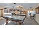 Spacious game room featuring multiple pool tables, overhead lighting, and comfortable seating for residents' entertainment at 2400 E Baseline Ave # 228, Apache Junction, AZ 85119