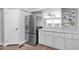 Bright kitchen featuring stainless steel refrigerator and white cabinets with counter space at 2400 E Baseline Ave # 228, Apache Junction, AZ 85119