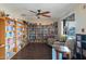 Bright and inviting library with extensive bookshelves, cozy seating, and plenty of natural light for reading and relaxation at 2400 E Baseline Ave # 228, Apache Junction, AZ 85119