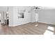 Open-concept living room with hardwood flooring, neutral paint, and views into the kitchen at 2400 E Baseline Ave # 228, Apache Junction, AZ 85119