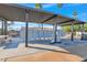 Community mailbox area with shaded seating and well-maintained landscaping, providing a social hub at 2400 E Baseline Ave # 228, Apache Junction, AZ 85119