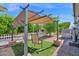 Cozy patio featuring a pergola, artificial grass, and outdoor seating for relaxation at 2400 E Baseline Ave # 228, Apache Junction, AZ 85119
