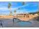Resort-style pool and spa area with palm trees, lounge chairs, and inviting community amenities at 2400 E Baseline Ave # 228, Apache Junction, AZ 85119