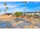 Community shuffleboard courts ready for play, surrounded by lush palm trees and seating areas at 2400 E Baseline Ave # 228, Apache Junction, AZ 85119